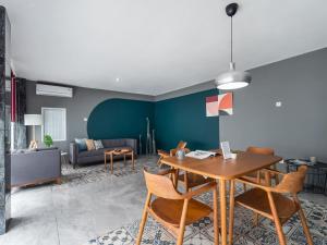 een woonkamer met een tafel en stoelen en een bank bij Cove Accordia Residence in Jakarta