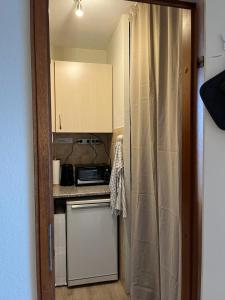 a small kitchen with a stove and a counter at Ferienwohnung an der Ostsee in Heiligenhafen +9 photos