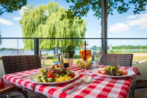 a table with two plates of food on top of it at Strandhaus am Inselsee in Güstrow +45 photos