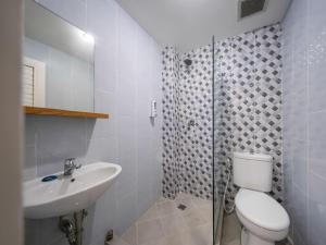 a bathroom with a toilet and a sink and a shower at Cove Accordia Residence in Jakarta