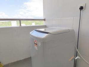 a trash can in a room with a window at Evernent's Homestay @ The Wharf in Miri