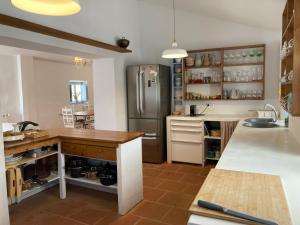 a kitchen with a stainless steel refrigerator and a counter at o meu monte in Évora