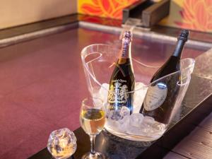 two bottles of champagne and two glasses on a table at HOTEL　Noblesse in Kobe