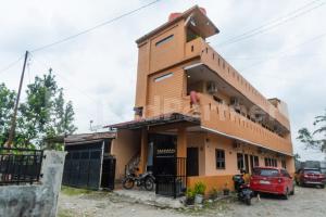 a building with a large gambrel at Teratai Guesthouse at RS Adam Malik Medan Mitra RedDoorz in Medan