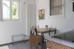 a kitchen and dining room with a table and chairs at Lake Thun Apartment for max 3 Guests Ideal for Water Sports & Swiss Alps in Thun