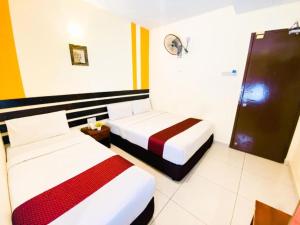 Postel nebo postele na pokoji v ubytování Sun Inns Hotel Puchong
