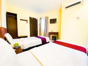 Postel nebo postele na pokoji v ubytování Sun Inns Hotel Puchong