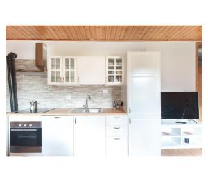a kitchen with white cabinets and a sink at Apartment Toni in Sarntal
