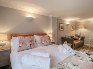 a bedroom with a bed with towels on it at Holly House Studio in Sudbury