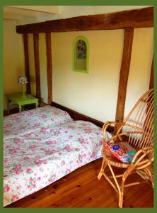 ein Schlafzimmer mit einem Bett und einem Schaukelstuhl in der Unterkunft Domaine Charente - Familyroom Gypsy with garden (with external toilet & shower house) in Mazières