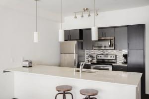 a kitchen with a counter and stools in it at Bellevue 2br w yoga studio nr restaurants SEA-628 in Redmond