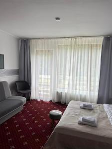 Postel nebo postele na pokoji v ubytování Pensiunea Crescent Predeal