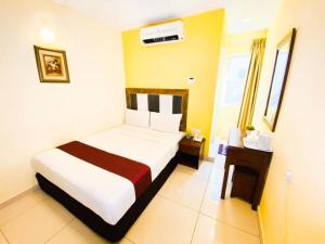 Postel nebo postele na pokoji v ubytování Sun Inns Hotel Puchong