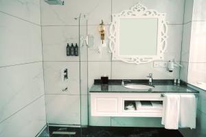 a bathroom with a sink and a mirror at Qrista Managed by Dedeman in Kars