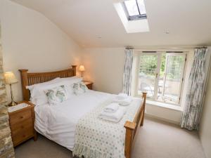 a bedroom with a bed with towels on it at Old Bothy in Shipston-on-Stour