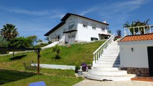 a white house on top of a hill with stairs at Quinta Do Forno in Vimeiro