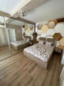 a bedroom with two beds and a mirror at Abel Apartment in Pomorie