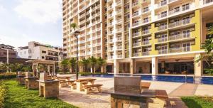 a building with tables and benches in front of it at Casa Concha by Celandine private residences in Manila