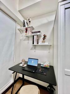 a desk with a laptop on it in a room at Casa Concha by Celandine private residences in Manila