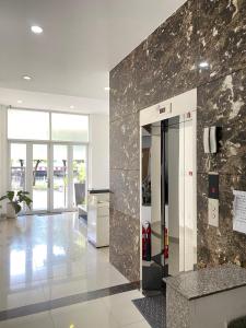 an office lobby with a marble wall at Sunrisehome in Ho Chi Minh City