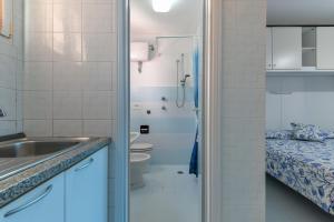 a bathroom with a sink and a toilet and a shower at Villa Oda - Monolocale sul mare in Capoliveri