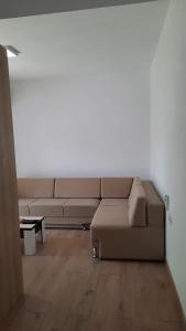 a living room with a couch and a table at City Center Apartment Vjosa River in Memaliaj