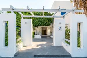 an entrance to a house with white doors at Hippocampus Hotel in Kamari