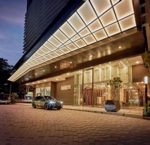 a car parked in front of a building at Societe Hartamas by Lyfehaus in Kuala Lumpur