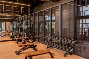 a gym with several rows of exercise equipment at Societe Hartamas by Lyfehaus in Kuala Lumpur