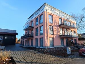 een roze gebouw met veel ramen bij Jolle 54 in Putbus