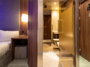 a hotel room with a bed and a bathroom at Bloc Hotel Birmingham in Birmingham