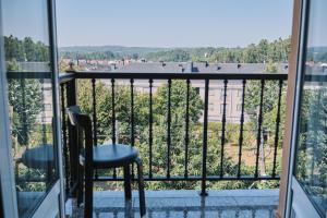 a balcony with a chair and a view at Peregrina Pensión 6 in O Pedrouzo