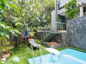 a swimming pool with a toilet and a house at Cove Birah Senopati in Jakarta