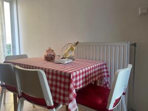 a table with a red and white checkered table cloth at COZY & QUIET CITY APARTMENT in Tríkala