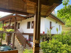 a house with a wooden roof and a patio at Вила Любима in Yakovtsi