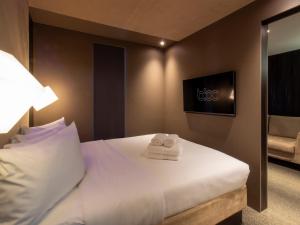 a hotel room with a bed with towels on it at Bloc Hotel Birmingham in Birmingham