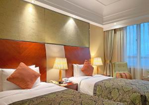 a hotel room with two beds and a window at Merry Hotel Shanghai in Shanghai +128 photos