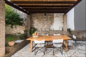 a wooden table and chairs on a patio at Villa in Pylos in Pylos