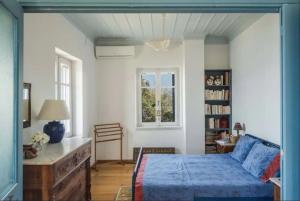 a bedroom with a bed and a couch and a window at Villa in Pylos in Pylos