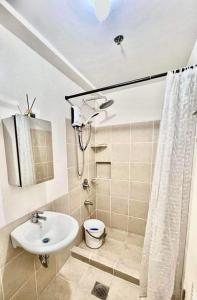a bathroom with a sink and a toilet and a shower at Casa Concha by Celandine in Manila