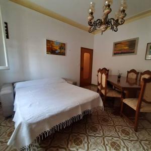 a bedroom with a bed and a table and chairs at Casa Val Mezzano in Ferrara