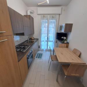 a kitchen with a table and a stove top oven at Casa Val Mezzano in Ferrara