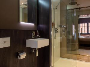 a bathroom with a sink and a shower at Bloc Hotel Birmingham in Birmingham
