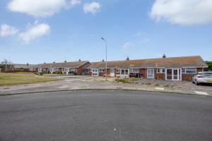 a row of houses in a parking lot at Amazing Beachside 2BD Family Home with Garden in Cliftonville