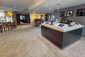 a lobby with a reception desk in a store at Village Hotel Cardiff in Cardiff