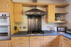 a kitchen with a stove top oven in a kitchen at Osprey View in Lochearnhead