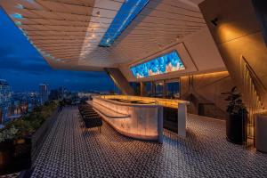 a bar on a building with a view of a city at INNSiDE by Meliá Bangkok Sukhumvit in Bangkok