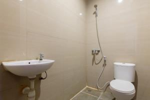 a bathroom with a toilet and a sink at RedDoorz @ Raya Ngagel 2 in Surabaya +14 photos