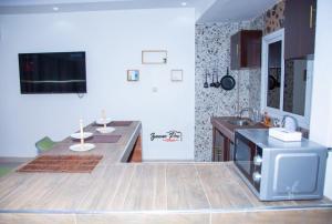 a kitchen with a counter and a sink in it at CAB LFS SIPRES MOURTADA 3e ETAGE in Dakar