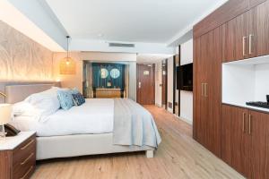 a bedroom with a bed and a flat screen tv at Sir Anthony in Playa de las Americas